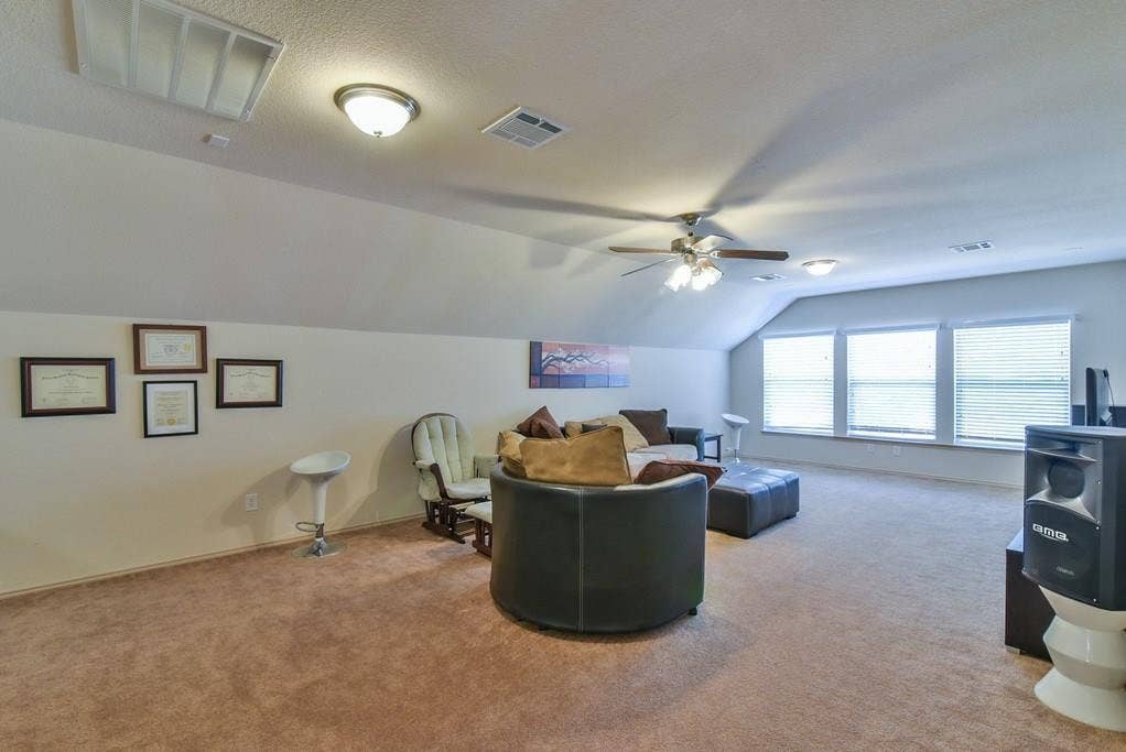 2705 Fox Creek Trail, Arlington, TX 76017 Spacious bonus room featuring sloped ceilings, recessed lighting, a ceiling fan, and light brown carpeting