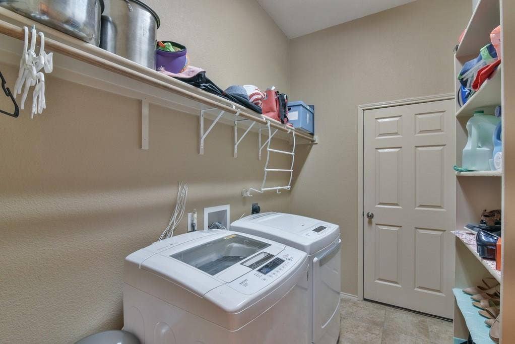 2705 Fox Creek Trail, Arlington, TX 76017 Dedicated laundry space featuring a practical overhead shelf, built-in storage shelving, and neutral wall paint