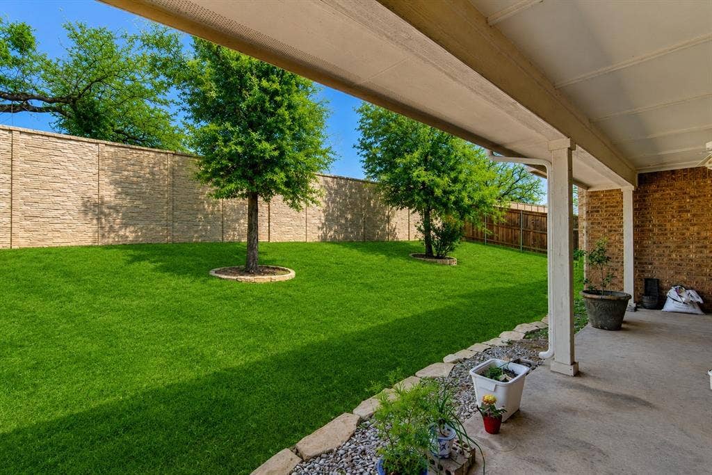 2705 Fox Creek Trail, Arlington, TX 76017 Covered patio with concrete flooring, brick exterior, and white support columns
