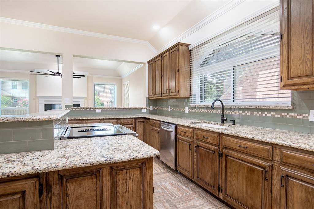 1405 Faringdon Drive, Plano, TX 75075 Kitchen with granite countertops and large island with bar top.