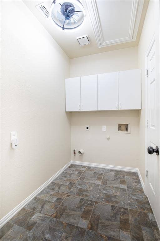 1405 Faringdon Drive, Plano, TX 75075 Laundry room with built-in cabinetry.