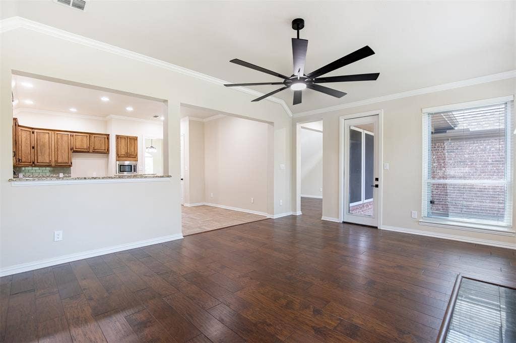1405 Faringdon Drive, Plano, TX 75075 Living room with exterior door leading to patio.