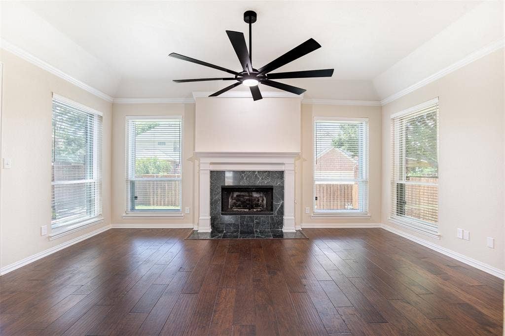 1405 Faringdon Drive, Plano, TX 75075 Living room anchored by a cozy fireplace with marble surround.