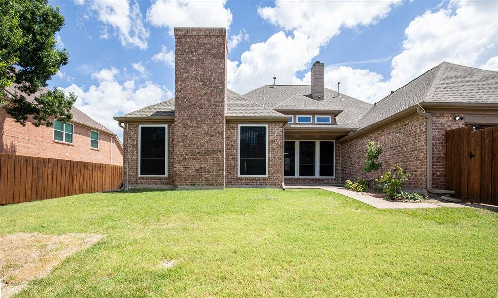 1405 Faringdon Drive, Plano, TX 75075 Backyard showcasing grassy yard.