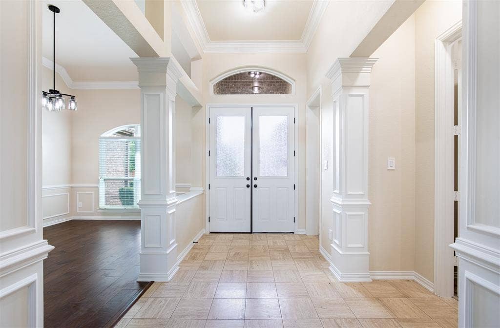 1405 Faringdon Drive, Plano, TX 75075 Grand entry with tall ceilings, crown molding, and double-door entry.