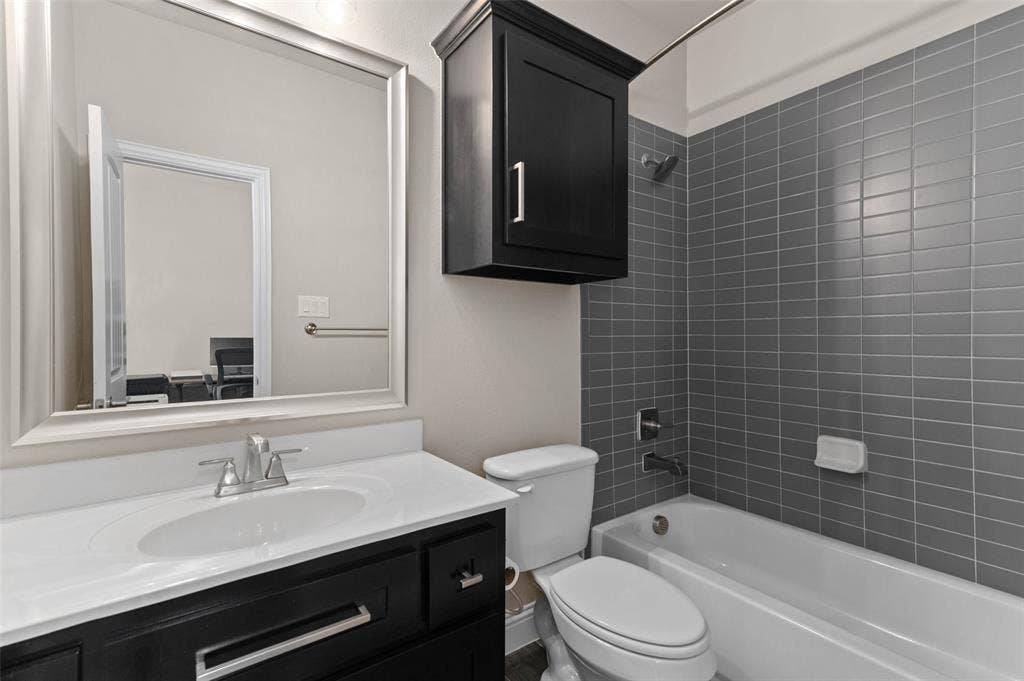 800 Beckington Drive, Shady Shores, TX 76208 Bathroom featuring a dark wood-finish vanity with a white countertop, chrome fixtures, and a framed mirror