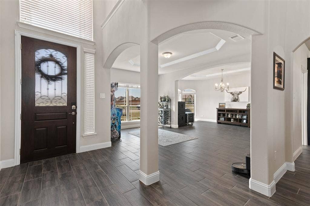 800 Beckington Drive, Shady Shores, TX 76208 Grand entry foyer featuring wood-finish tile flooring, a dark wood entry door with ornate glass detailing!