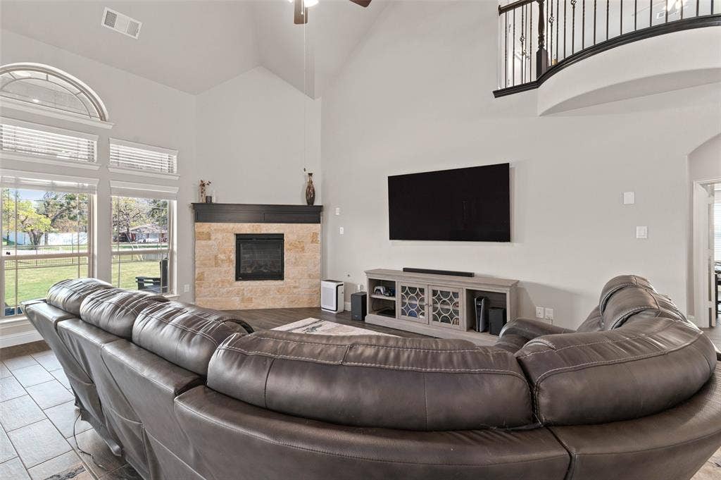 800 Beckington Drive, Shady Shores, TX 76208 Spacious living area featuring a vaulted ceiling and an upper-level balcony with wrought iron railing