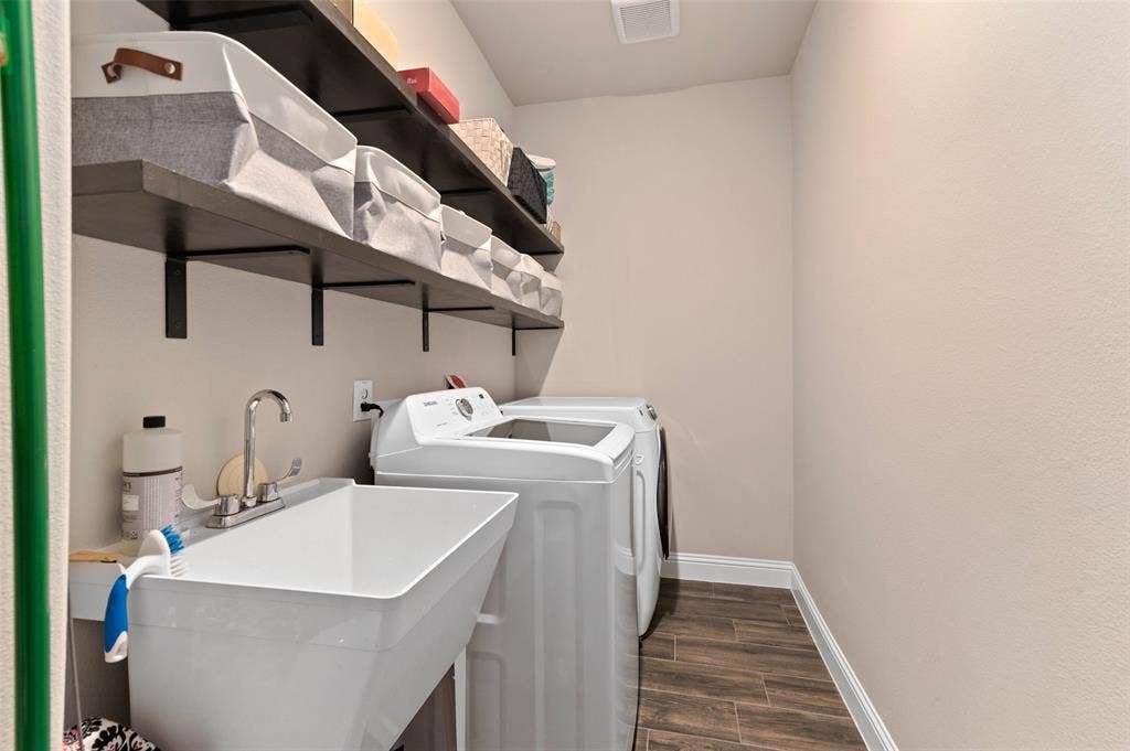 800 Beckington Drive, Shady Shores, TX 76208 Dedicated laundry area featuring wood-finish tile flooring, a utility sink with a chrome faucet, and integrated shelving