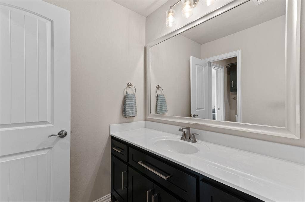 800 Beckington Drive, Shady Shores, TX 76208 Bathroom vanity featuring a white countertop, undermount sink, and brushed nickel faucet
