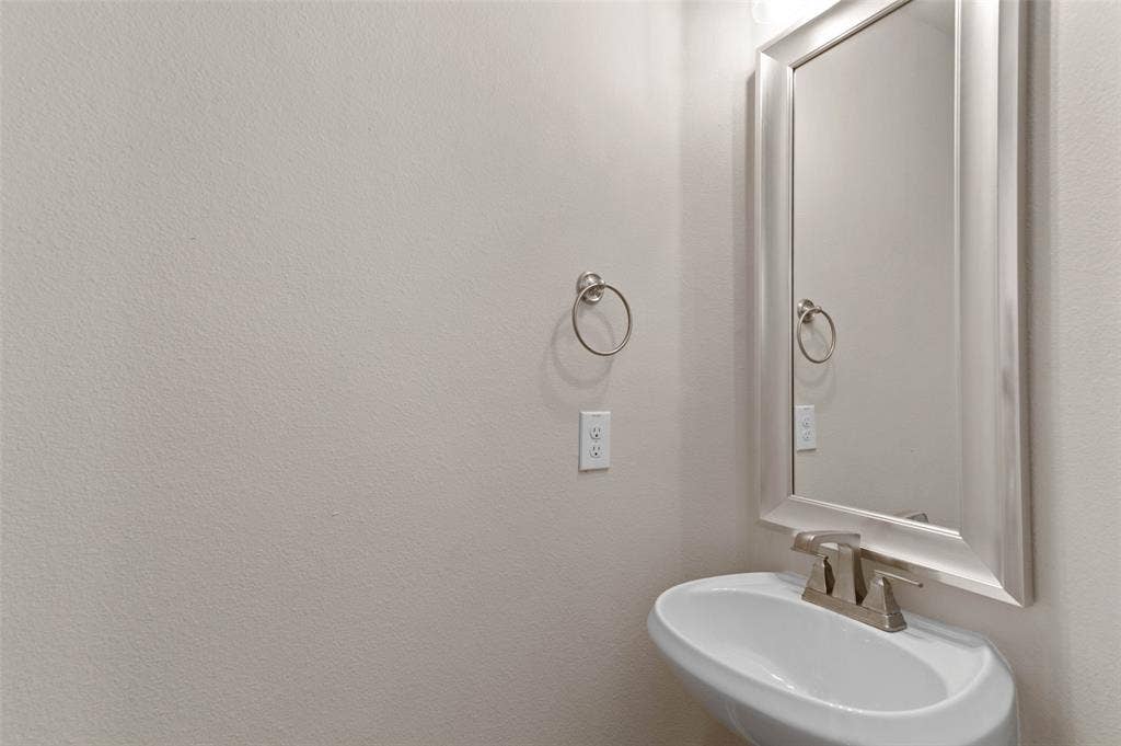 800 Beckington Drive, Shady Shores, TX 76208 Half Bath upstairs with Pedestal sink with a two-handle faucet, framed mirror, and a wall-mounted towel ring