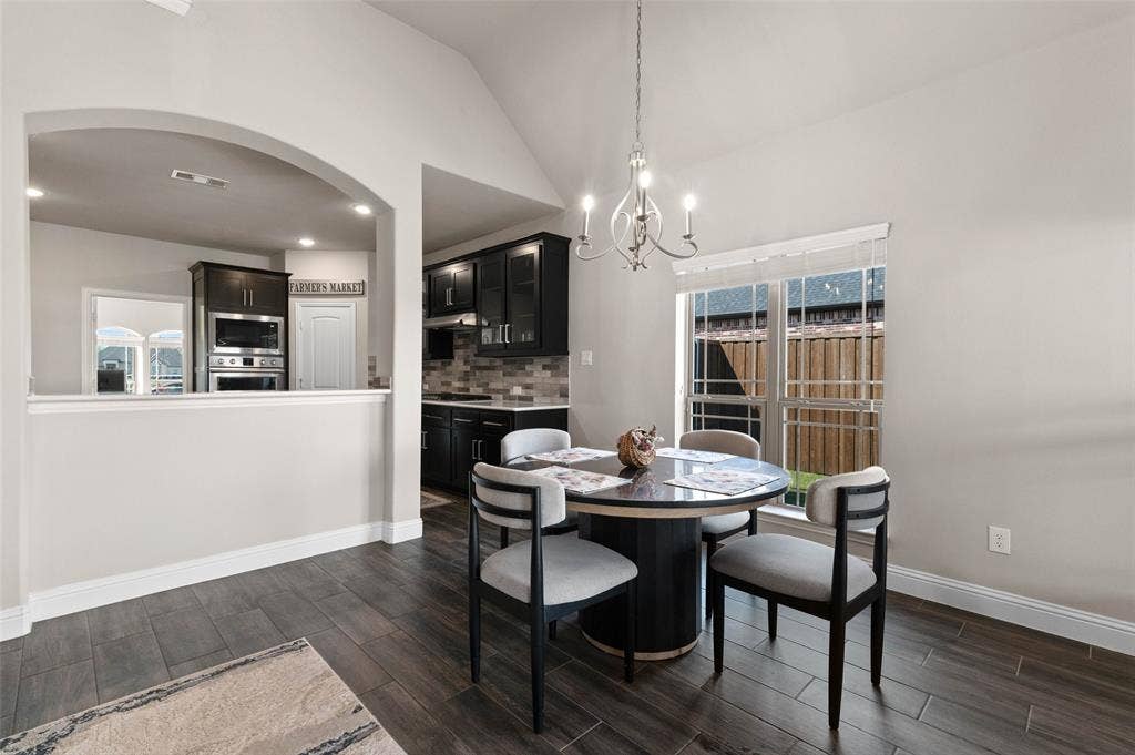 800 Beckington Drive, Shady Shores, TX 76208 Dining area featuring wood-finish flooring, a contemporary chandelier, and a large window