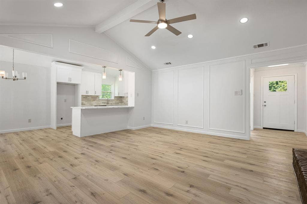 3406 Windridge Drive, Garland, TX 75043 Open-concept living space with vaulted ceilings, wood-finish flooring, and recessed lighting