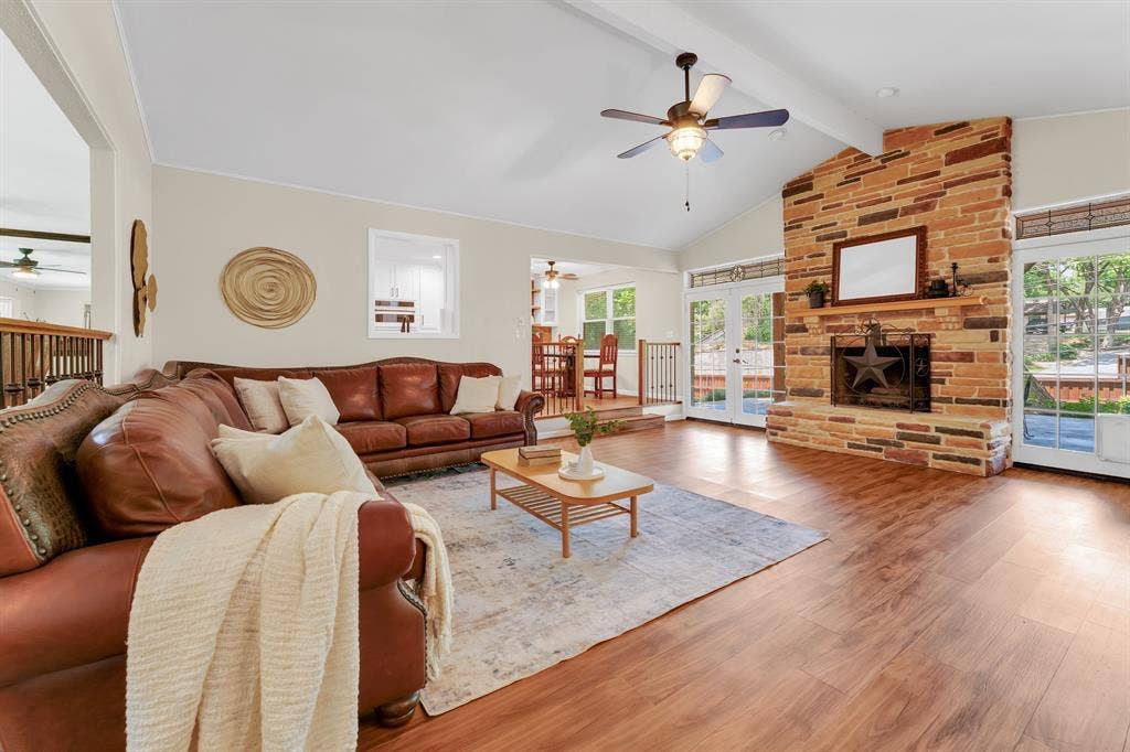 3908 Wildwood, Euless, TX 76040 Spacious living area featuring a vaulted ceiling and wood-finish flooring