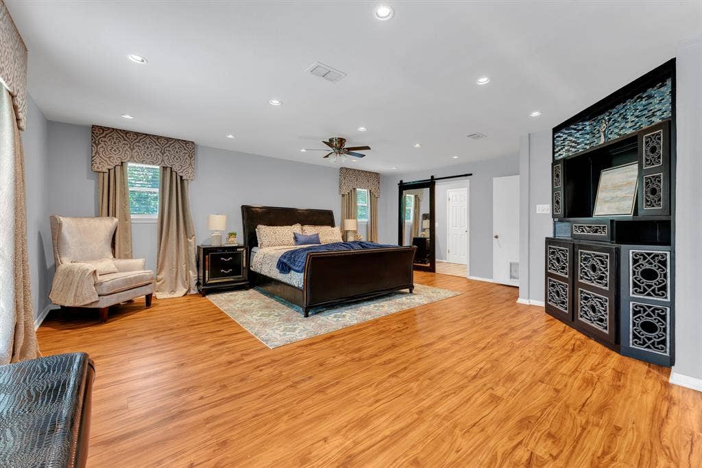 3908 Wildwood, Euless, TX 76040 Spacious room featuring wood-finish flooring, recessed lighting, and a ceiling fan