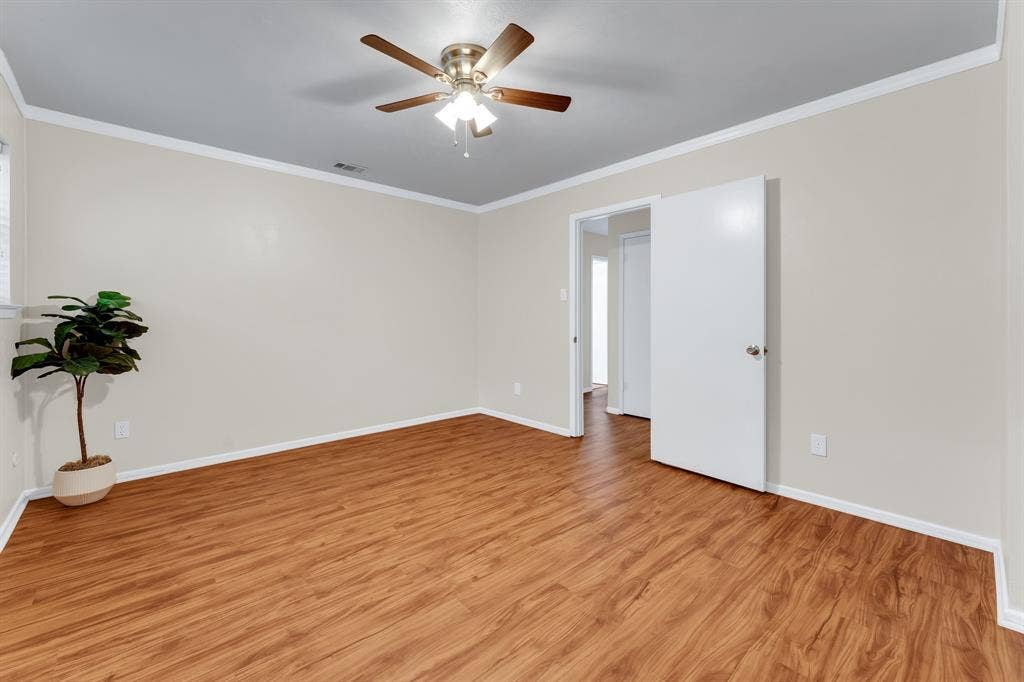 3908 Wildwood, Euless, TX 76040 bedroom #3 with wood-finish flooring, light-toned walls, and white baseboards