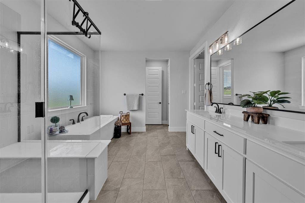 2004 Willy Dilly Road, Springtown, TX 76082 Double vanity with white cabinetry, matte black hardware, and integrated sinks