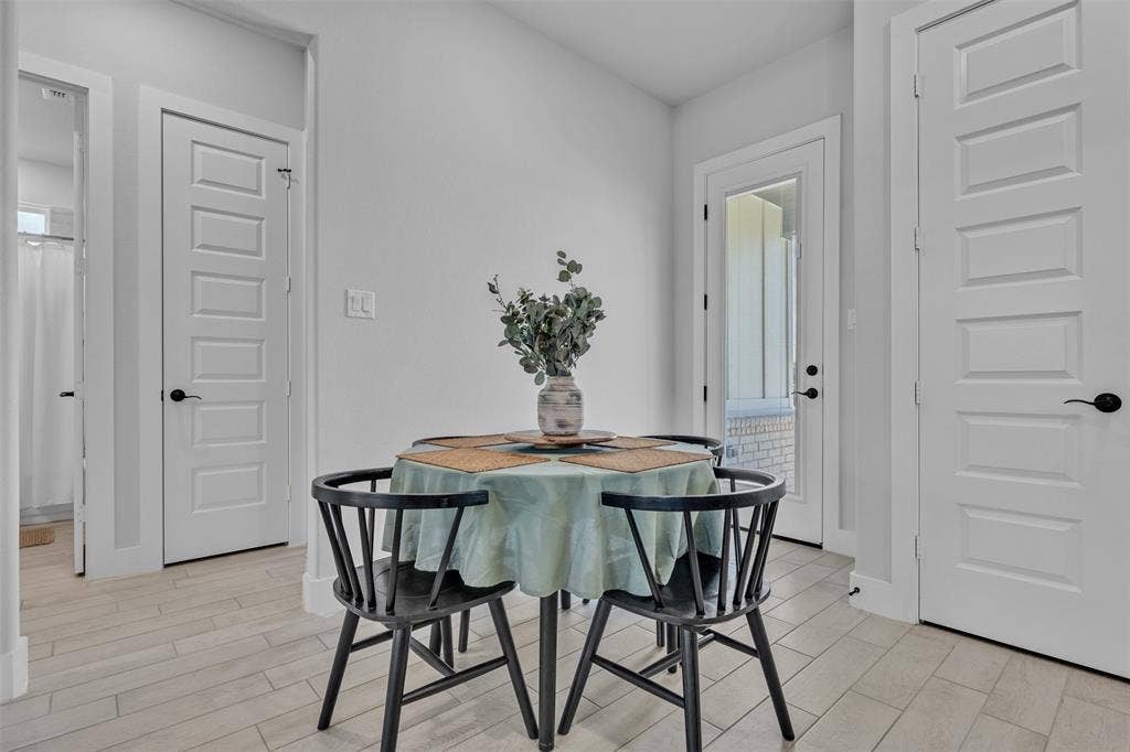 2004 Willy Dilly Road, Springtown, TX 76082 Bedroom featuring a wood-finish headboard, twin windows with blinds and drapery, and wall-mounted sconces