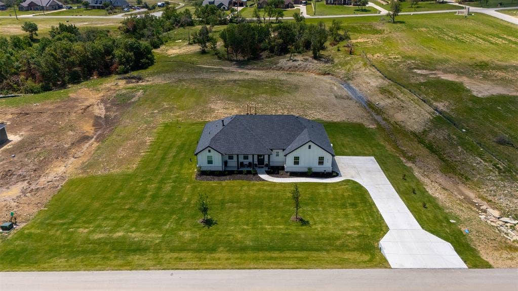2004 Willy Dilly Road, Springtown, TX 76082 Newly constructed single-story residence with a dark shingle roof and light-colored siding