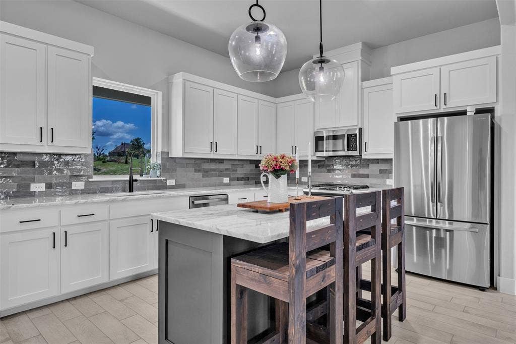 2004 Willy Dilly Road, Springtown, TX 76082 Stainless steel gas range with a coordinating microwave oven and range hood