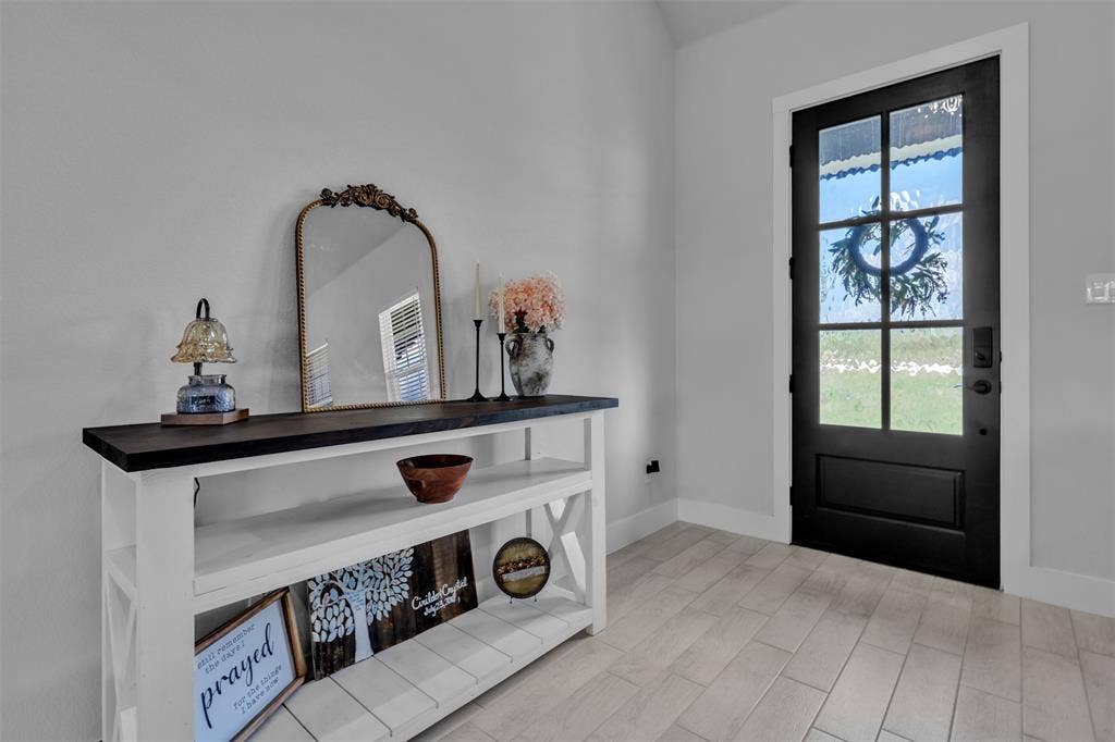 2004 Willy Dilly Road, Springtown, TX 76082 White-trimmed fireplace with a glass-front insert and log media