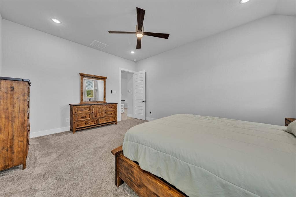 2004 Willy Dilly Road, Springtown, TX 76082 Carpeted room with a single window featuring blinds and white curtains