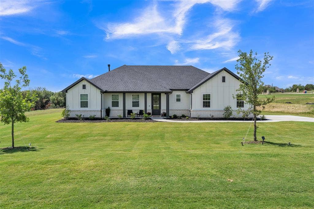 2004 Willy Dilly Road, Springtown, TX 76082 White siding exterior with a dark gray shingle roof and a concrete driveway
