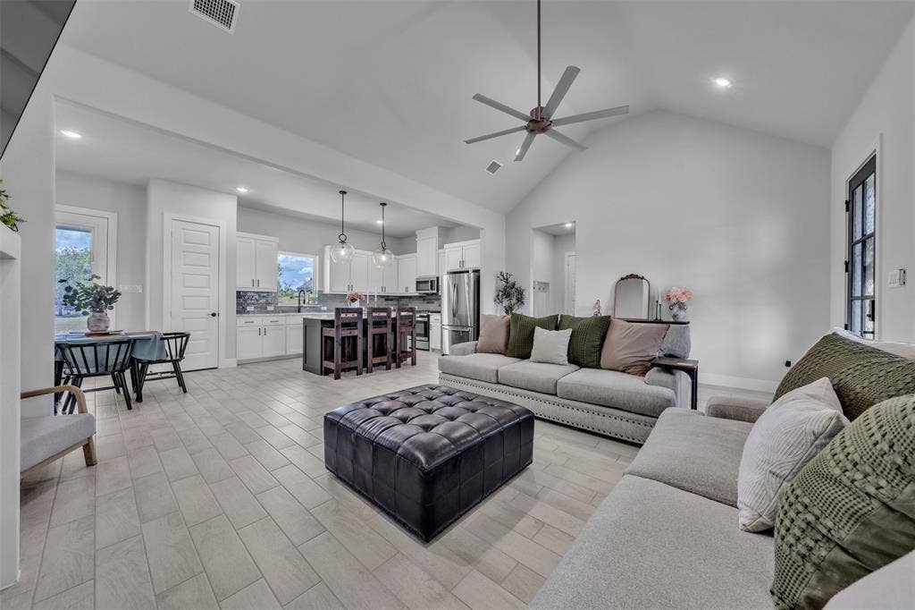 2004 Willy Dilly Road, Springtown, TX 76082 Open-concept living space featuring wood-finish flooring, vaulted ceilings, recessed lighting, and a modern ceiling fan