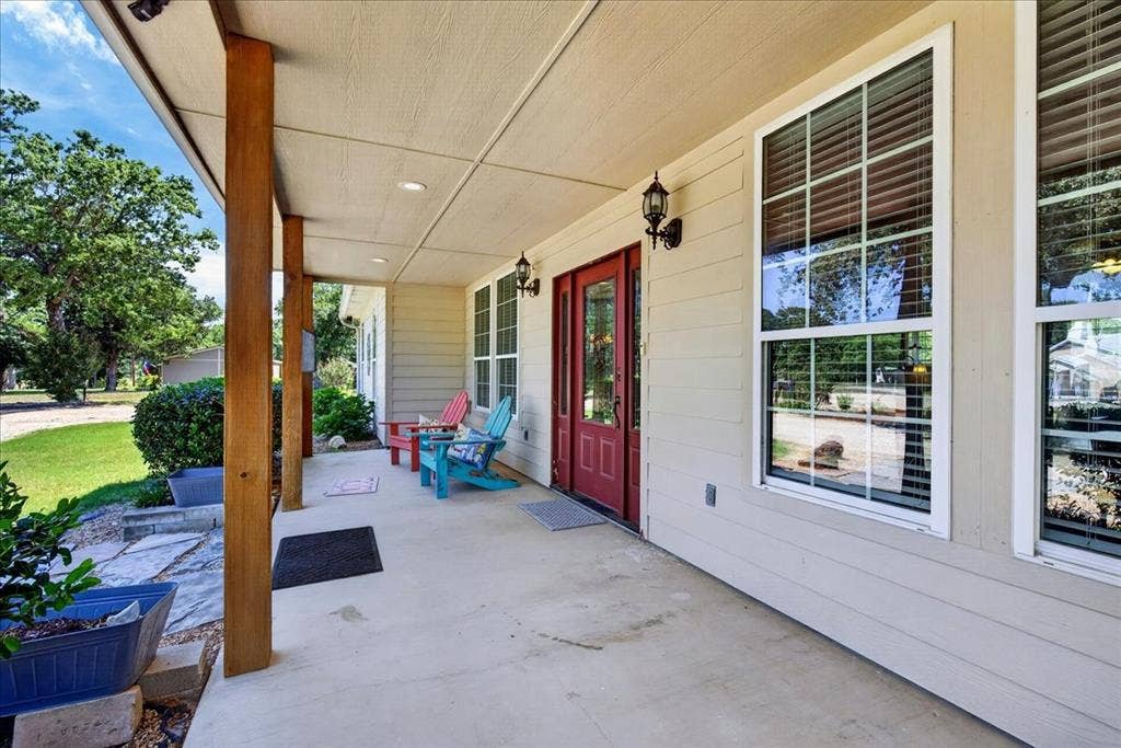 11591 Farm Market 59, Athens, TX 75751 Expansive front porch featuring exposed wood support beams and a concrete surface