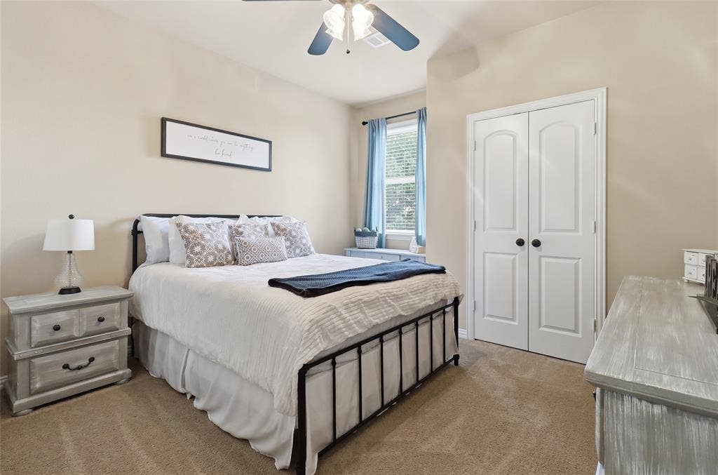 6905 Denali Drive, McKinney, TX 75070 Carpeted bedroom with neutral wall tones and a window featuring natural light