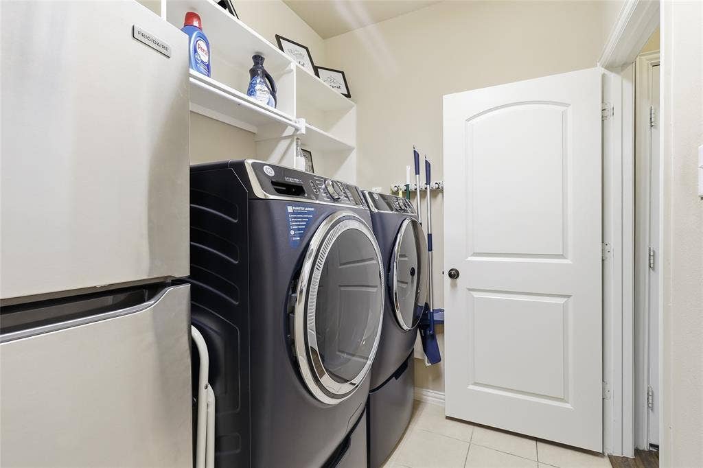 6905 Denali Drive, McKinney, TX 75070 Laundry room featuring light-colored walls and tiled flooring