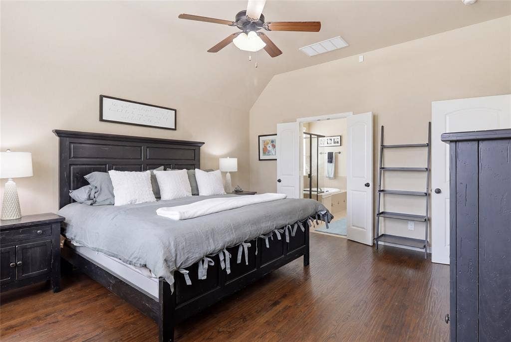 6905 Denali Drive, McKinney, TX 75070 Spacious bedroom featuring wood-finish flooring, vaulted ceilings, and a ceiling fan