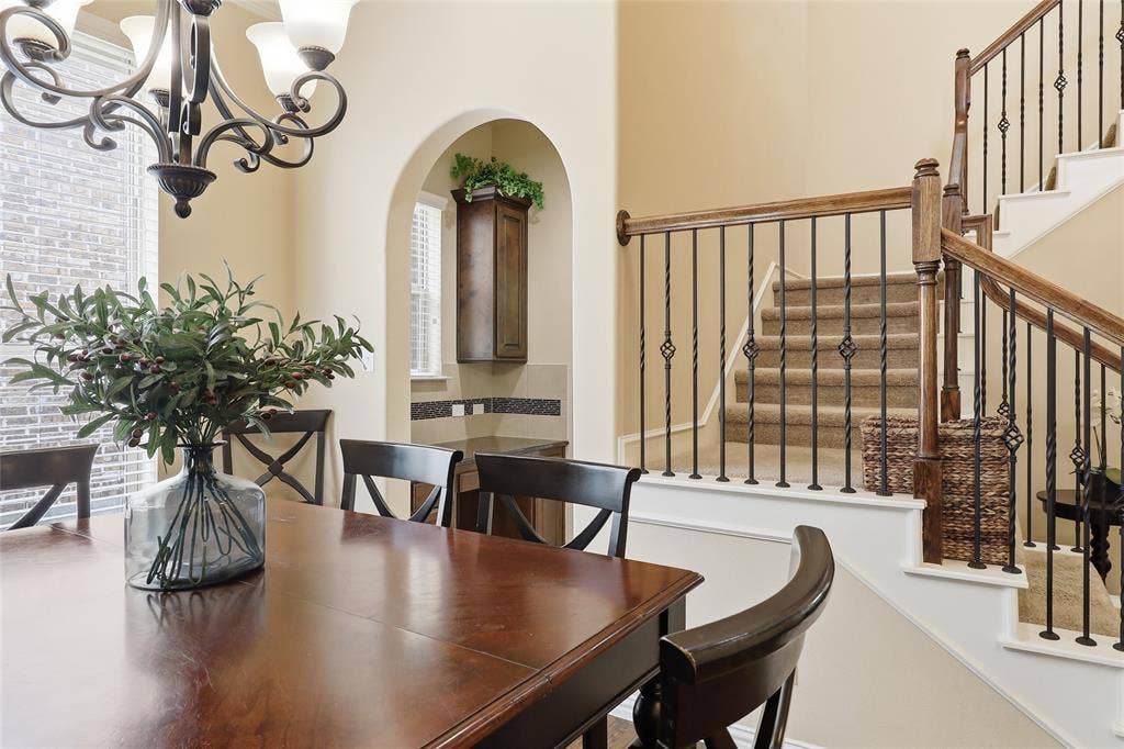 6905 Denali Drive, McKinney, TX 75070 Crafted staircase featuring wood handrails and wrought iron balusters
