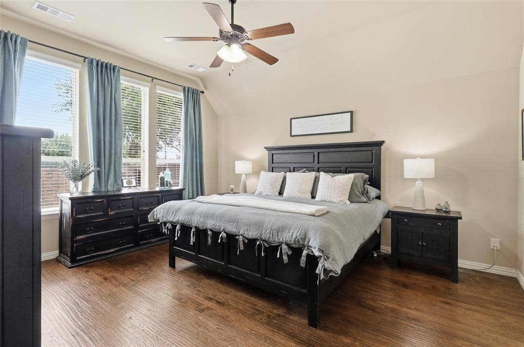 6905 Denali Drive, McKinney, TX 75070 Spacious room featuring wood-finish flooring, light tan walls, and a ceiling fan with integrated lighting