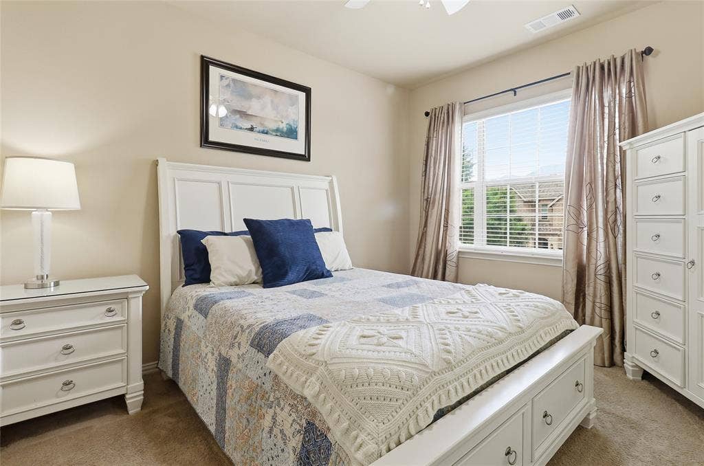 6905 Denali Drive, McKinney, TX 75070 Bedroom featuring a panel headboard, carpeted flooring, a window with blinds, and neutral wall tones