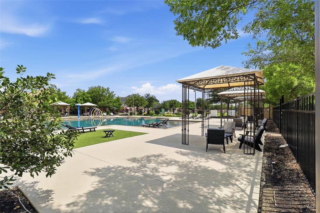 6905 Denali Drive, McKinney, TX 75070 Outdoor swimming area featuring multiple cabanas with seating, a large swimming pool, and dedicated lounging spaces with artificial turf accents