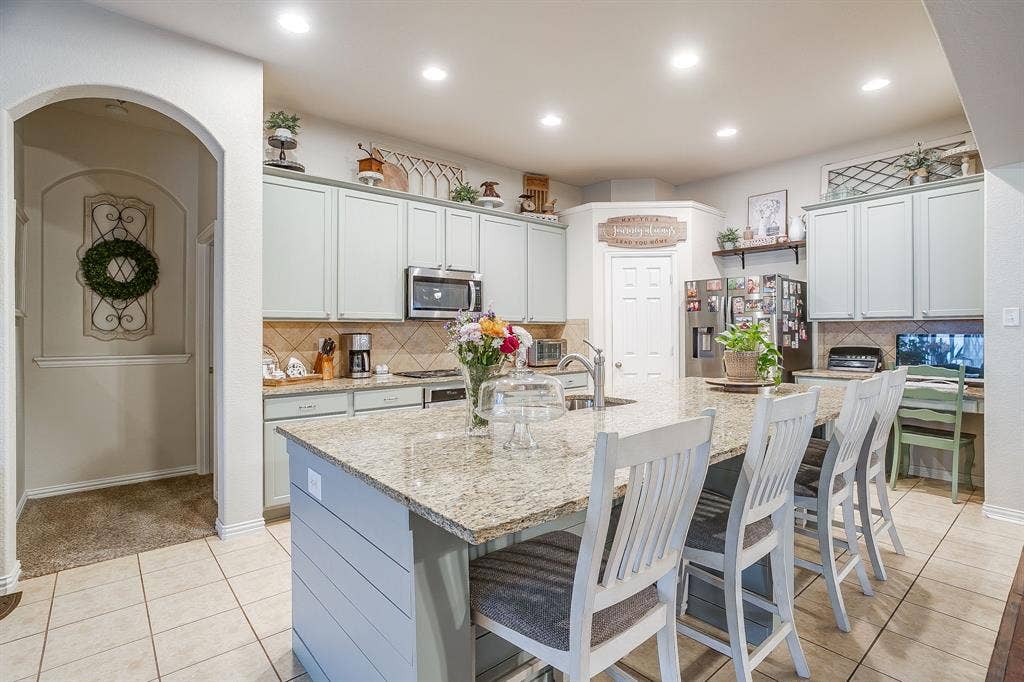 1316 Meadowlakes, Azle, TX 76020 Kitchen island with breakfast bar and sink.