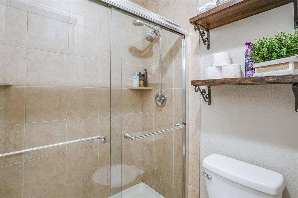 1316 Meadowlakes, Azle, TX 76020 Glass doors and tile shower in guest bath.