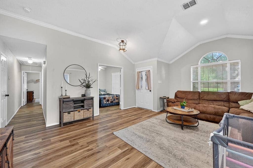 Vaulted ceilings with crown molding accent the main living area