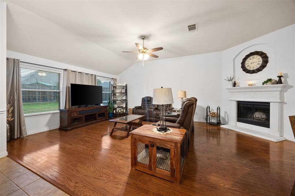 5209 Medallion Court, Midlothian, TX 76065 Spacious living space with wood burning fireplace.