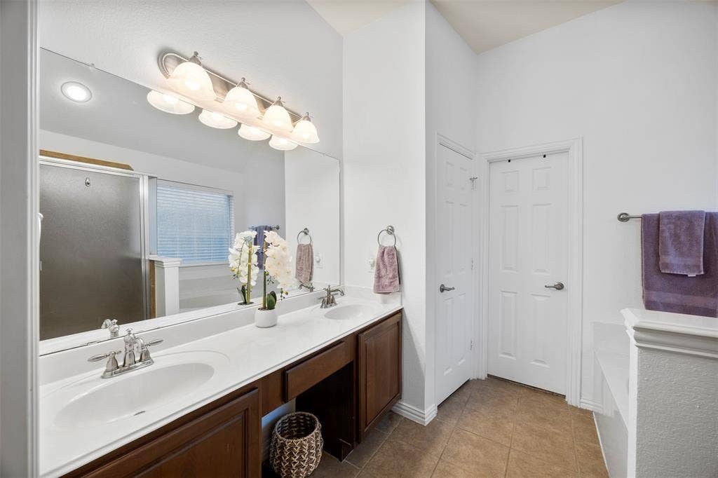 5209 Medallion Court, Midlothian, TX 76065 Primary bath with dual sinks, garden tub, separate shower, and walk-in-closet.
