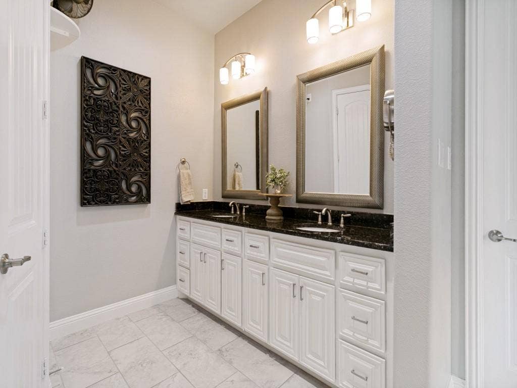 720 Hampshire Drive, Prosper, TX 75078 Primary bathroom with dual sinks and decorative lighting.