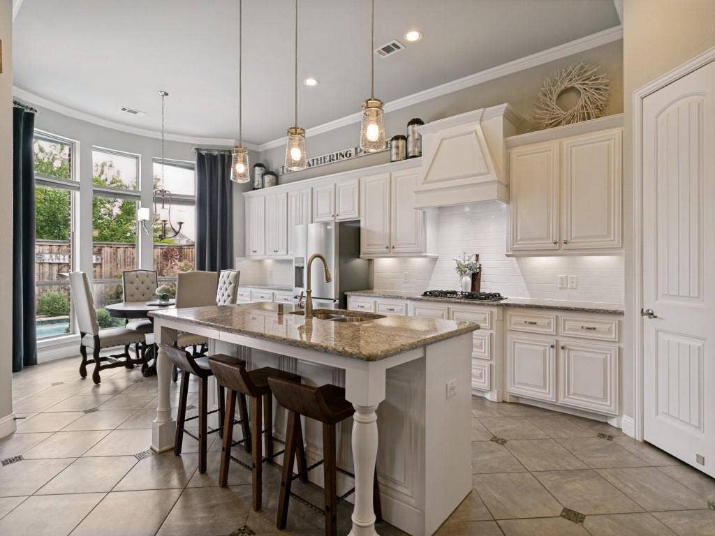 720 Hampshire Drive, Prosper, TX 75078 This gourmet kitchen comes with a large island you can dine in, pendant lighting and abundant storage.