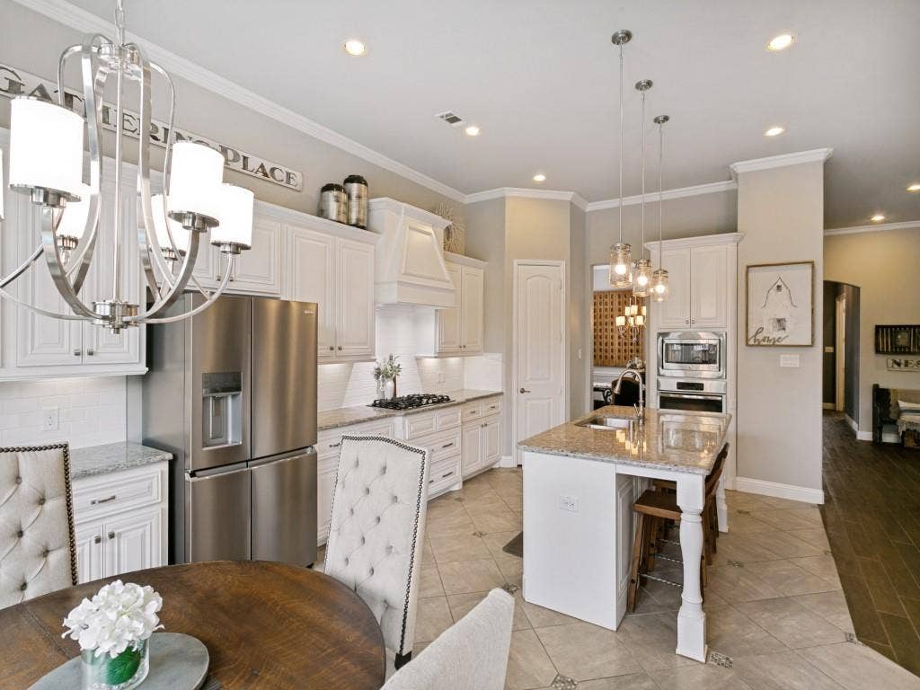 720 Hampshire Drive, Prosper, TX 75078 Kitchen includes stainless steel appliances, granite countertops and walk-in pantry.