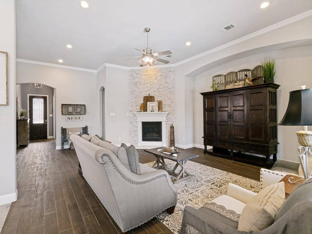 720 Hampshire Drive, Prosper, TX 75078 Large living room with ceiling fan and fireplace.