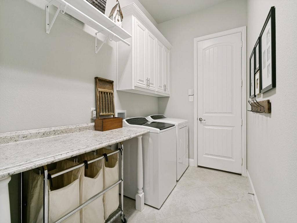 720 Hampshire Drive, Prosper, TX 75078 spacious laundry room with storage cabinets and room for folding and hanging clothes and near the door there is extra space for a freezer or additional fridge.