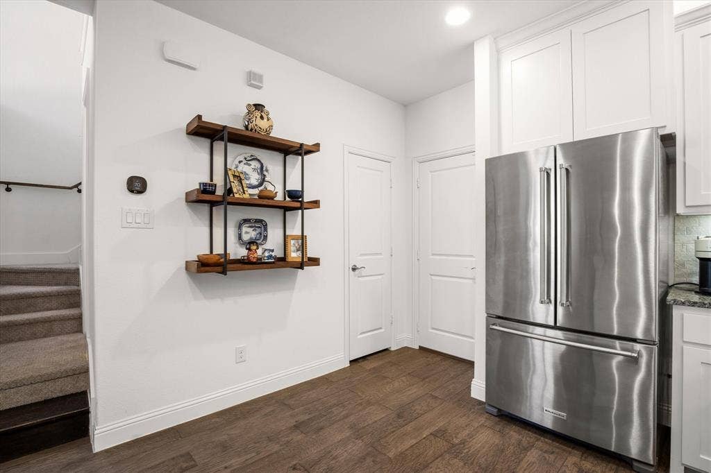 7221 Huckleberry Drive, McKinney, TX 75070 From the kitchen, there is an exit to the garage or a landing to the powder bath.