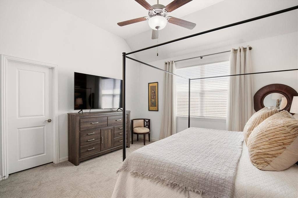 7221 Huckleberry Drive, McKinney, TX 75070 There is a large window flooding natural light into the primary bedroom.