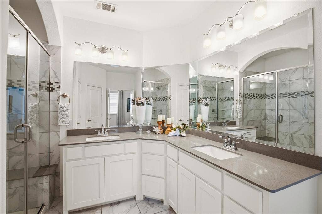 7221 Huckleberry Drive, McKinney, TX 75070 Mirrors and light make this primary bath special.