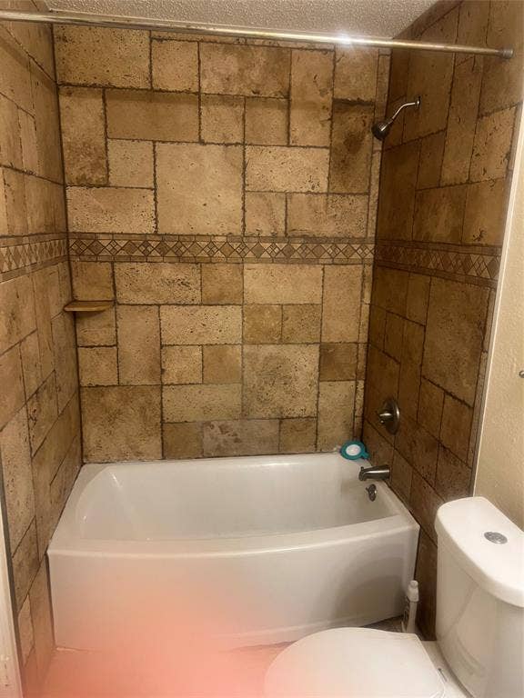 121 Brookside Drive, Duncanville, TX 75137 Shower-over-tub combination with textured stone-look tile surround and decorative mosaic accent band